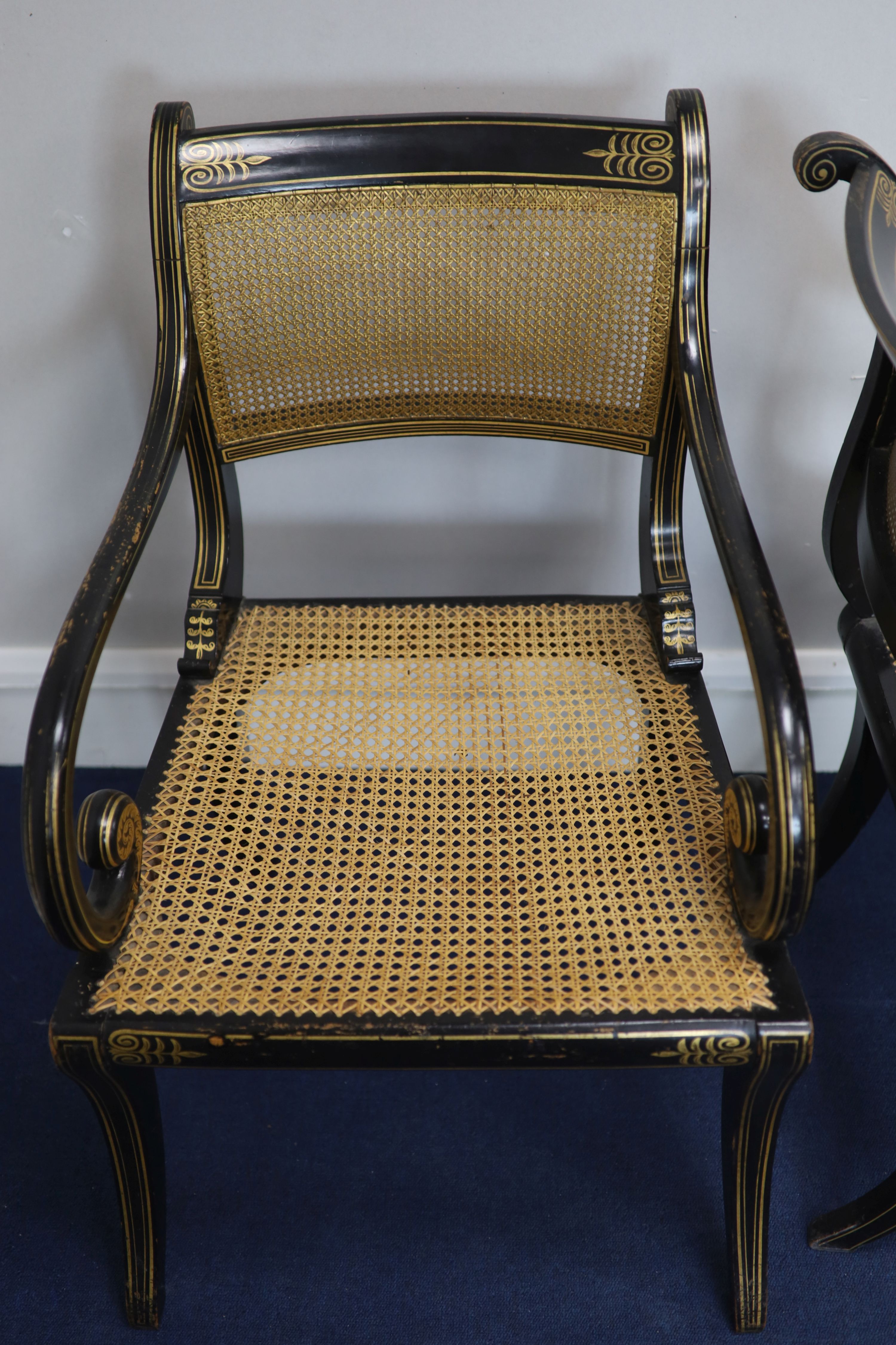 A set of seven Regency style parcel-gilt decorated ebonised armchairs, 19th century,